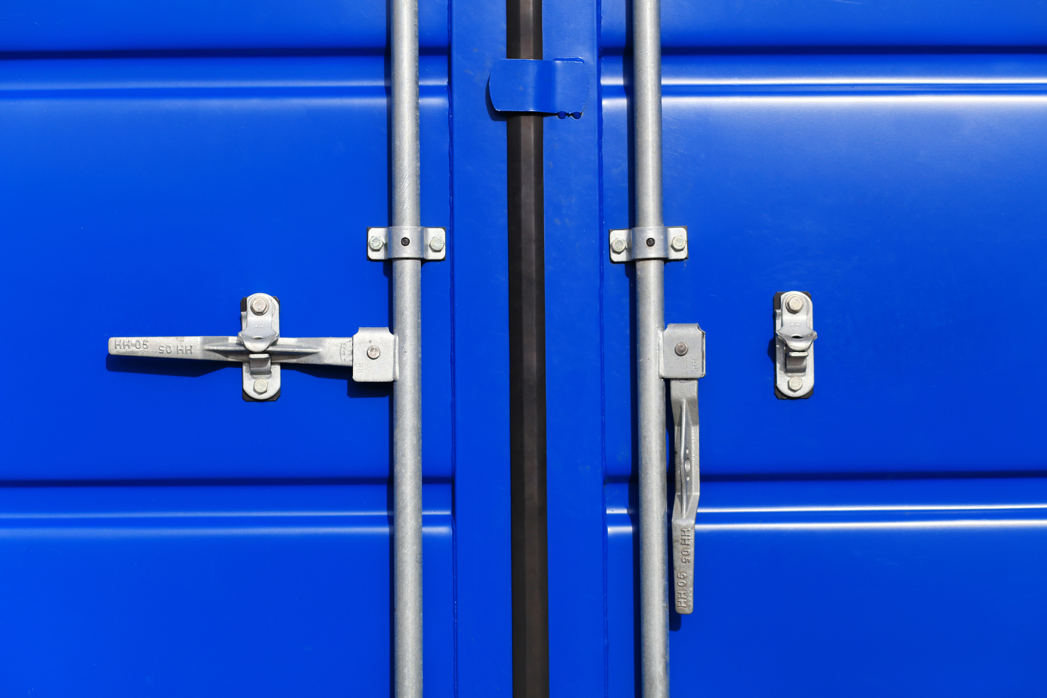 Close-up image of a lock on a cargo container. Containerized applications benefit from zero trust security principles, going beyond a simple "locked door" and preventing any actions without explicit permission.